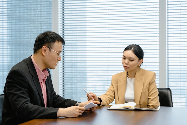 two people sitting across from each other in a meeting